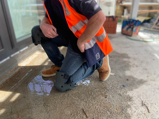 Tradegear Safety Kneepads on tradesperson kneeling on rough surface. 